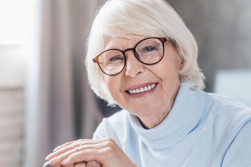 A senior lady is beaming with joy