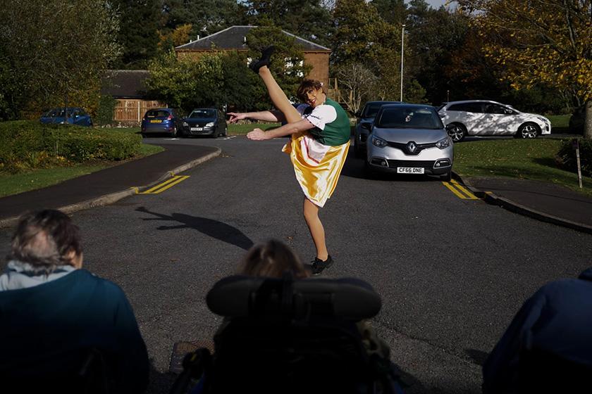 Sanctuary care staff member dancing in the street
