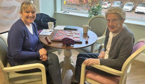 Tracey and her mum at Castlecroft Residential Care Home Mother and Daughter play scrabble smiling