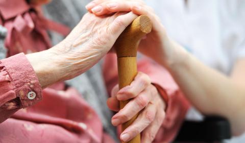 Elderly woman being comforted