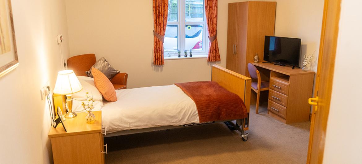Spacious bedroom with furnishings at Wantage Care Home in Oxfordshire