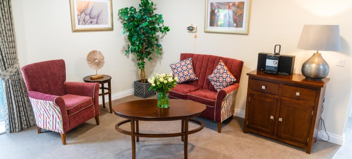 An armchair and sofa around a coffee table
