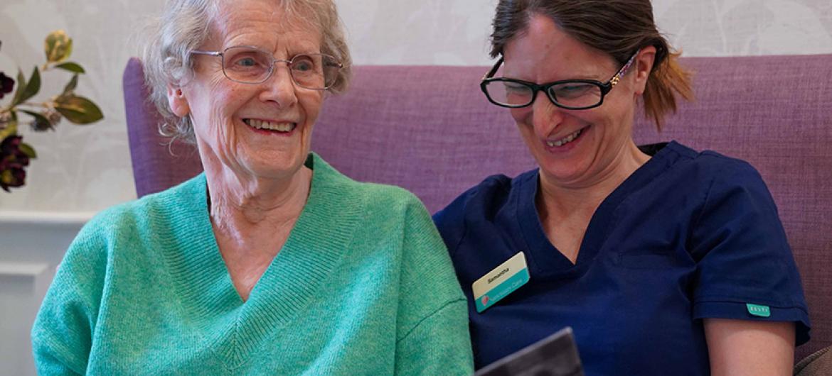 Photo of elderly lady with carer smiling