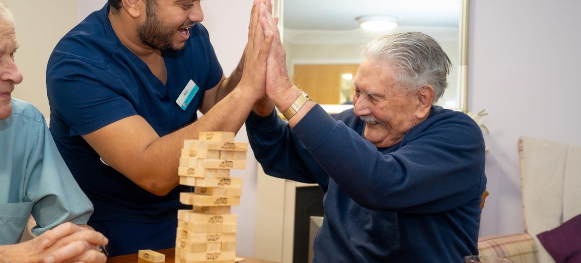 Resident and staff Smiling playing game