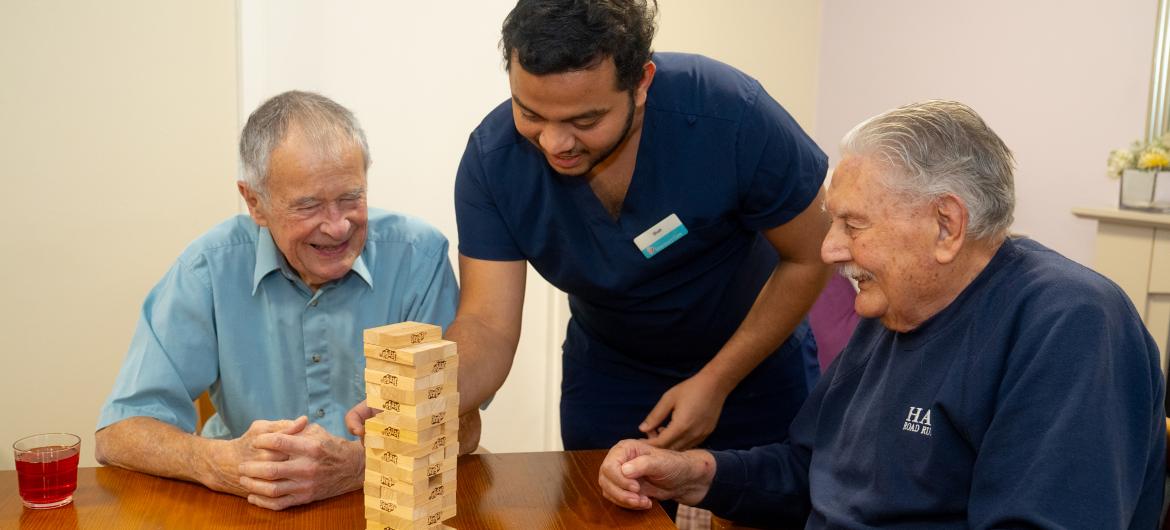 Resident and staff Smiling playing game