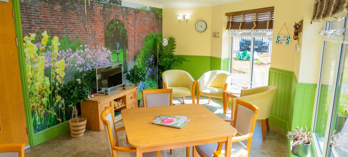 An activity room with tables and chairs