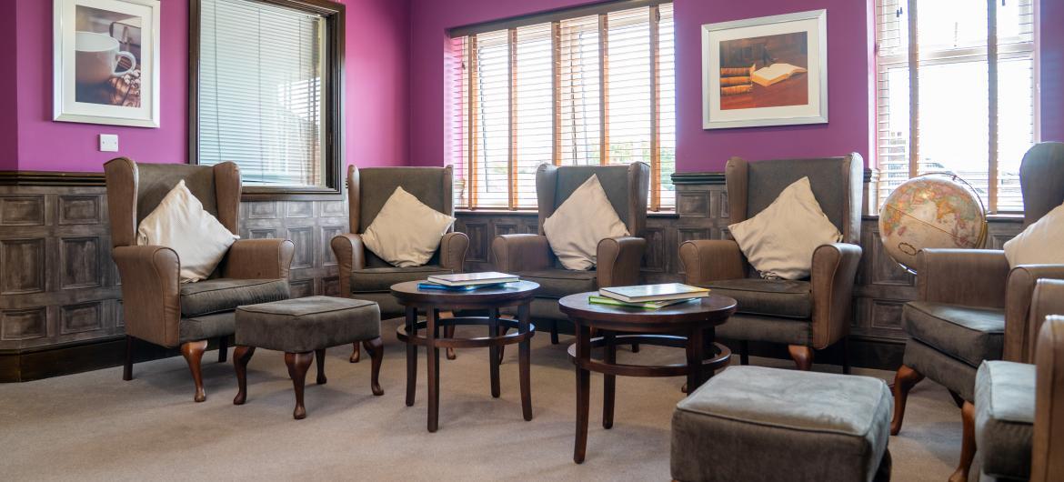 A light and airy room with comfortable leather arm chairs