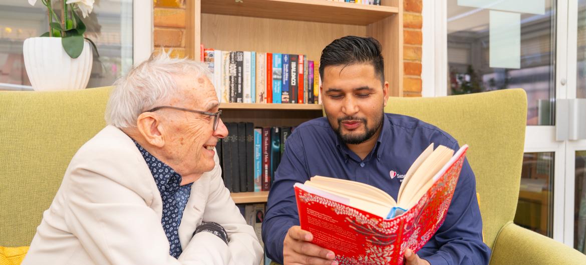 Resident and Carer in library