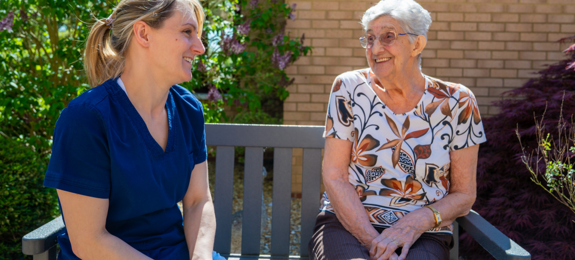 Resident and Carer sitting in Garden