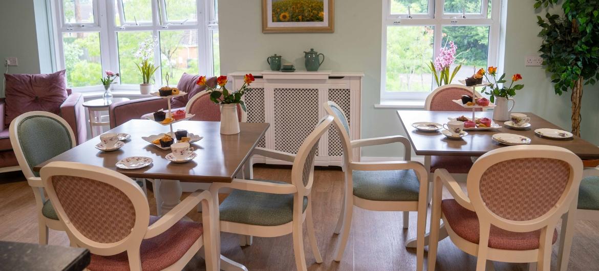 A beautifully laid dining room with large windows