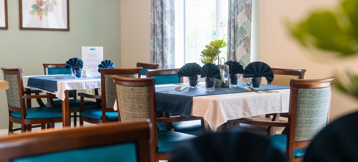 A beautifully laid dining room with blue table cloths