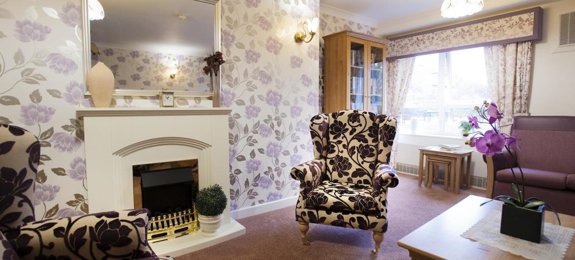 The lounge in the Regent Residential Care Home has comfy chairs and an open fire.