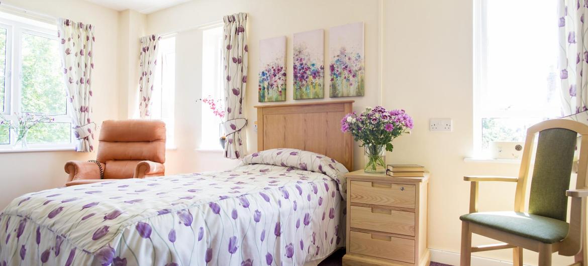 A dual aspect country-style bedroom at Shaftesbury House Residential Care Home.