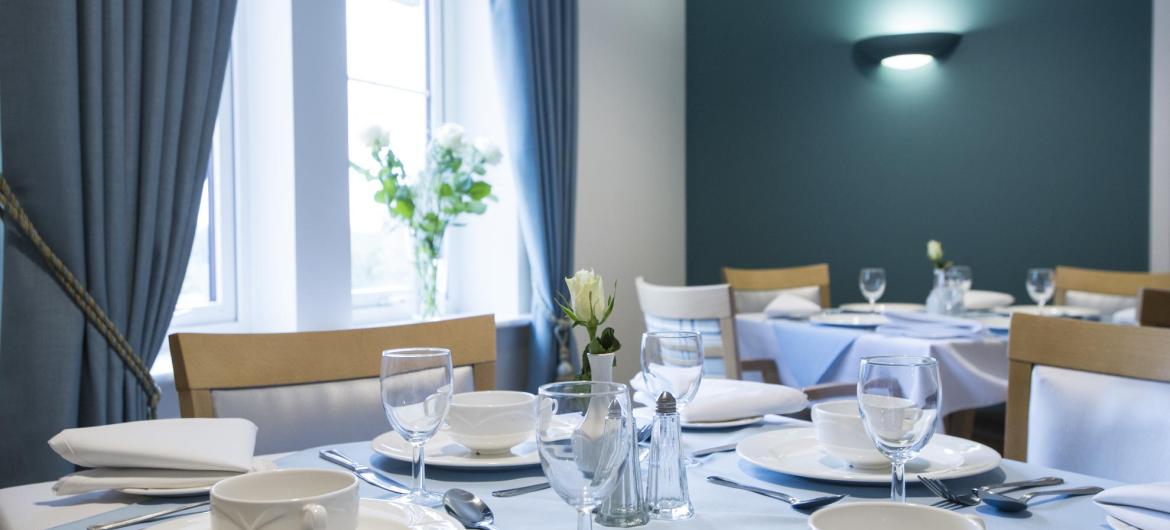 The tables set for dinner in the Juniper House Residential Care Home dining room.