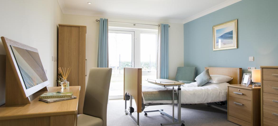A bright and airy bedroom at Meadow View Residential Care Home.