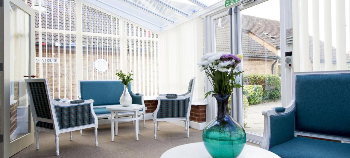 The conservatory provides plentiful seating to admire the gardens at Asra House Residential Care Home