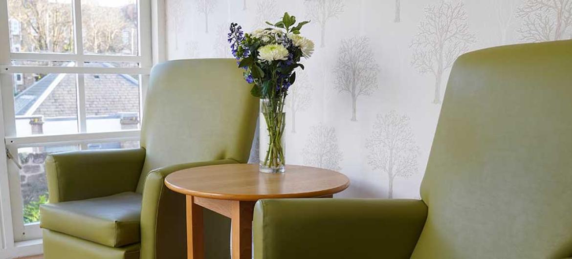 Two armchairs in a communal lounge area at Bridge View House