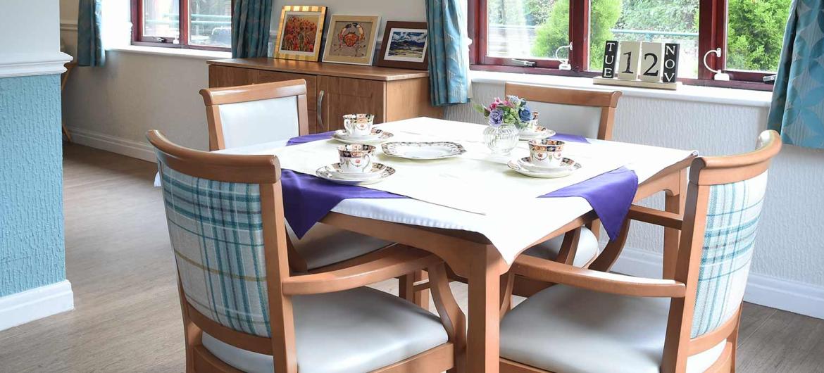 A table is set for two diners in the communal dining room at High Peak Nursing Home.