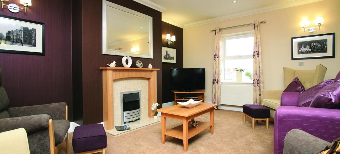 The fireplace and feature wall in the Highcroft Hall Residential Care Home.