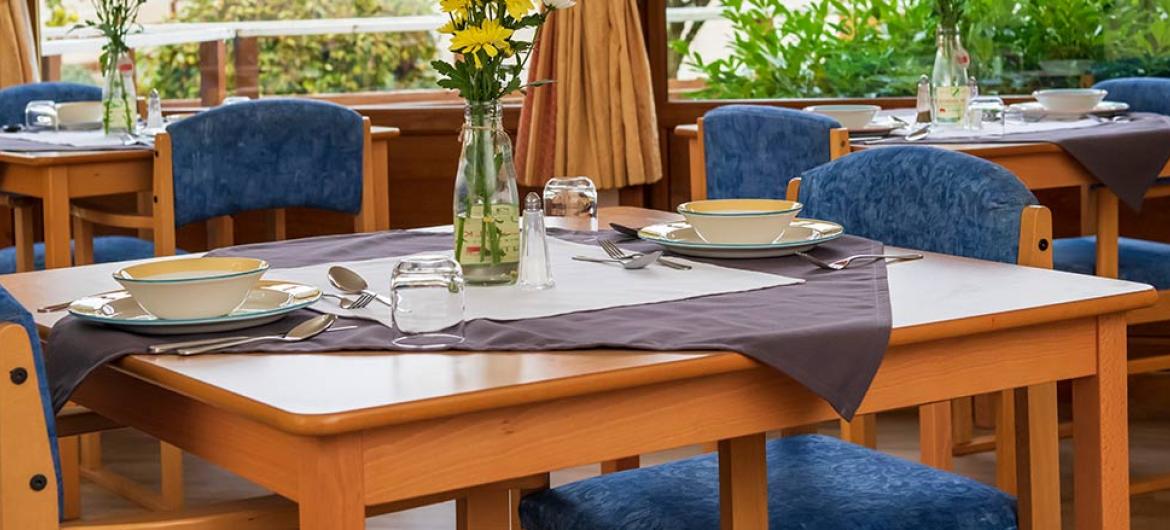 Spacious dining room areas offering lovely garden views at Mull Hall Care Home in Invergordon