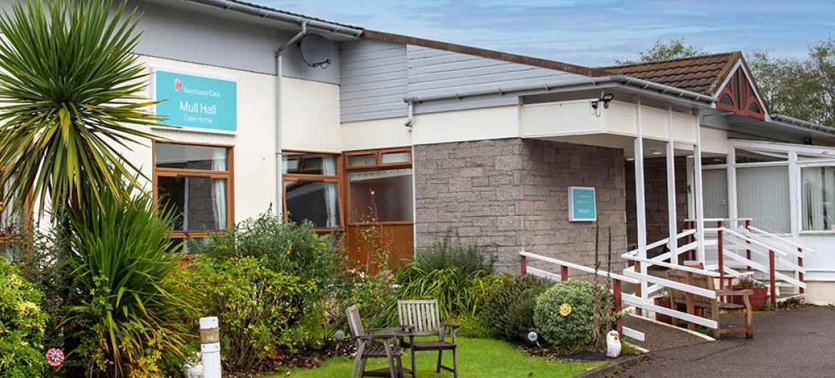 Exterior with outdoor seating area at Mull Hall Care Home in Invergordon