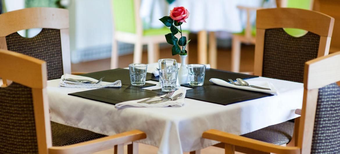 Places set for dinner service in the care home restaurant.