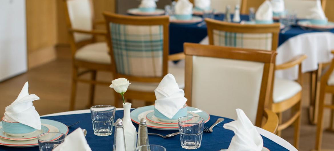 A dining table set up within the Riverlee dining room