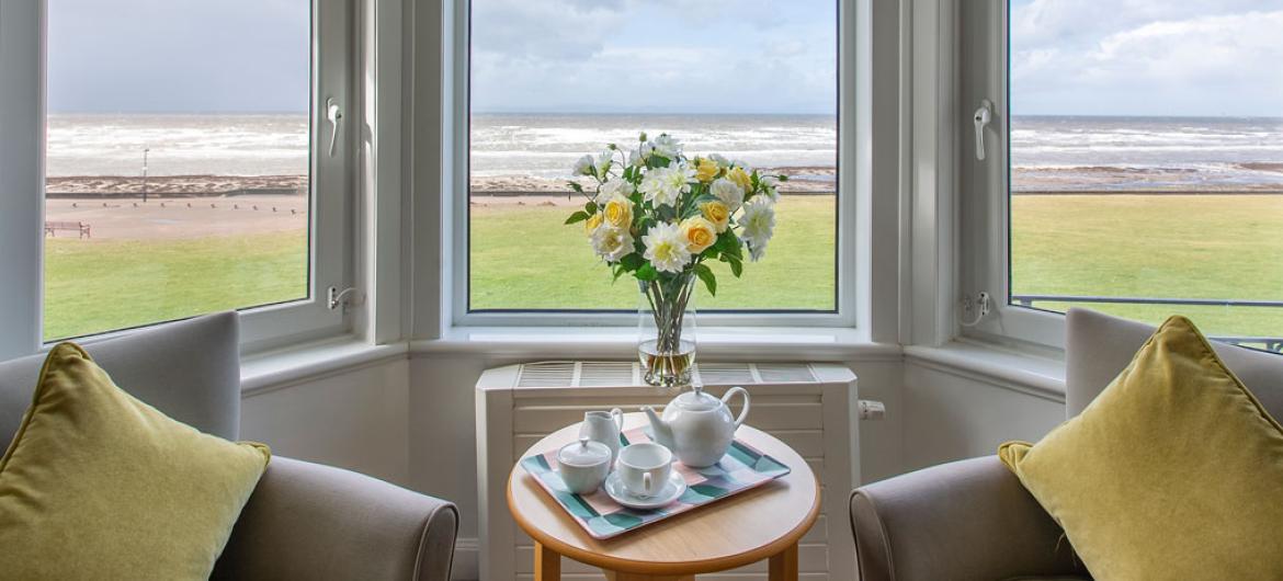 Queens care home lounge with a sea view