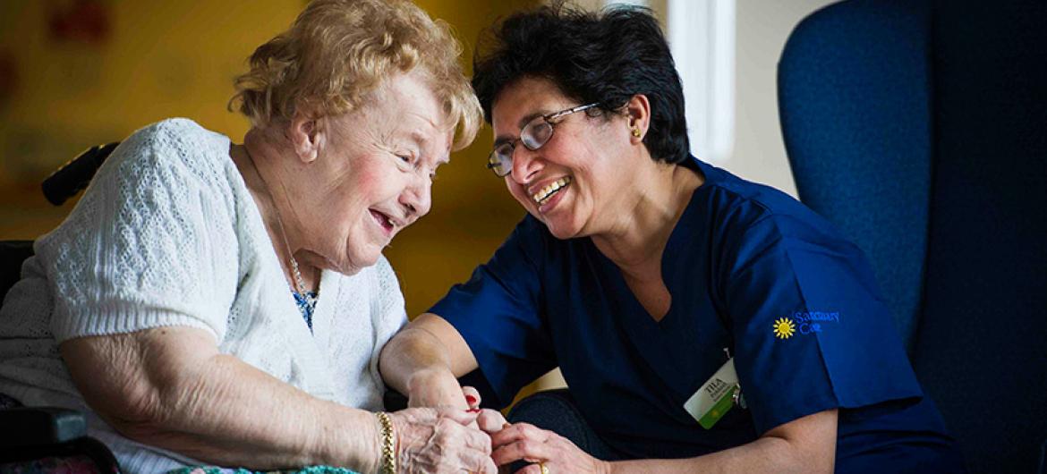 A Sanctuary Care nurse talks with a resident.