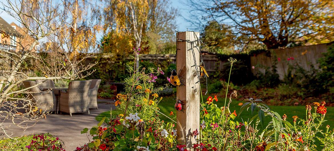 Stunning garden area with plants, trees and outdoor seating area at Wantage Care Home in Oxfordshire