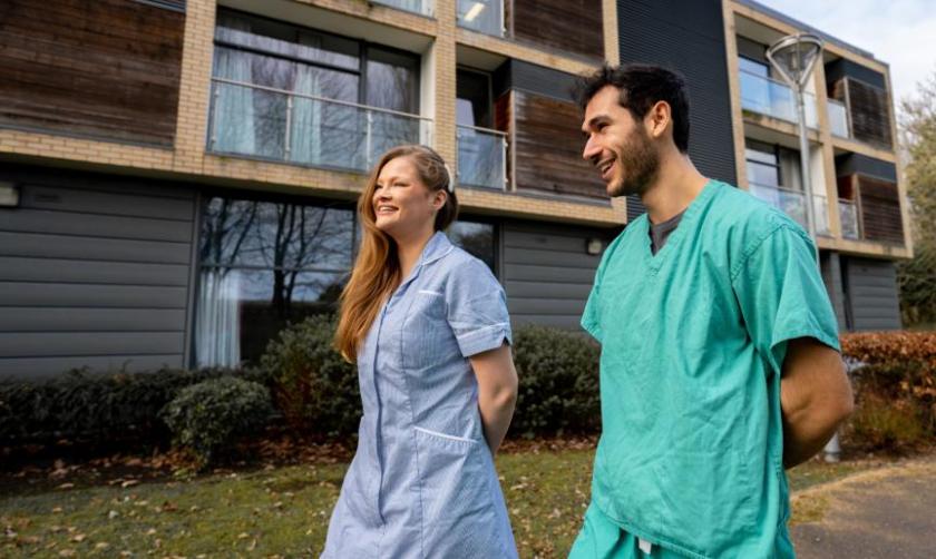 Two Sanctuary keyworkers walking outside an accommodation block