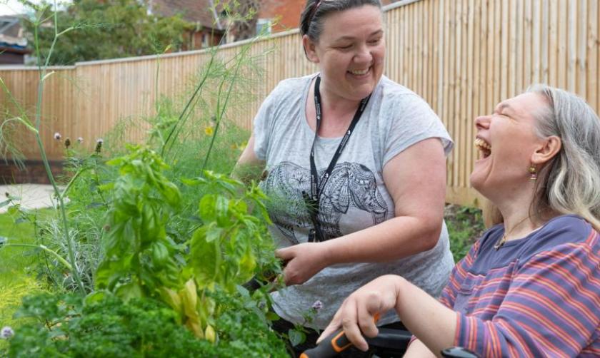 A sanctuary employee and resident gardening 