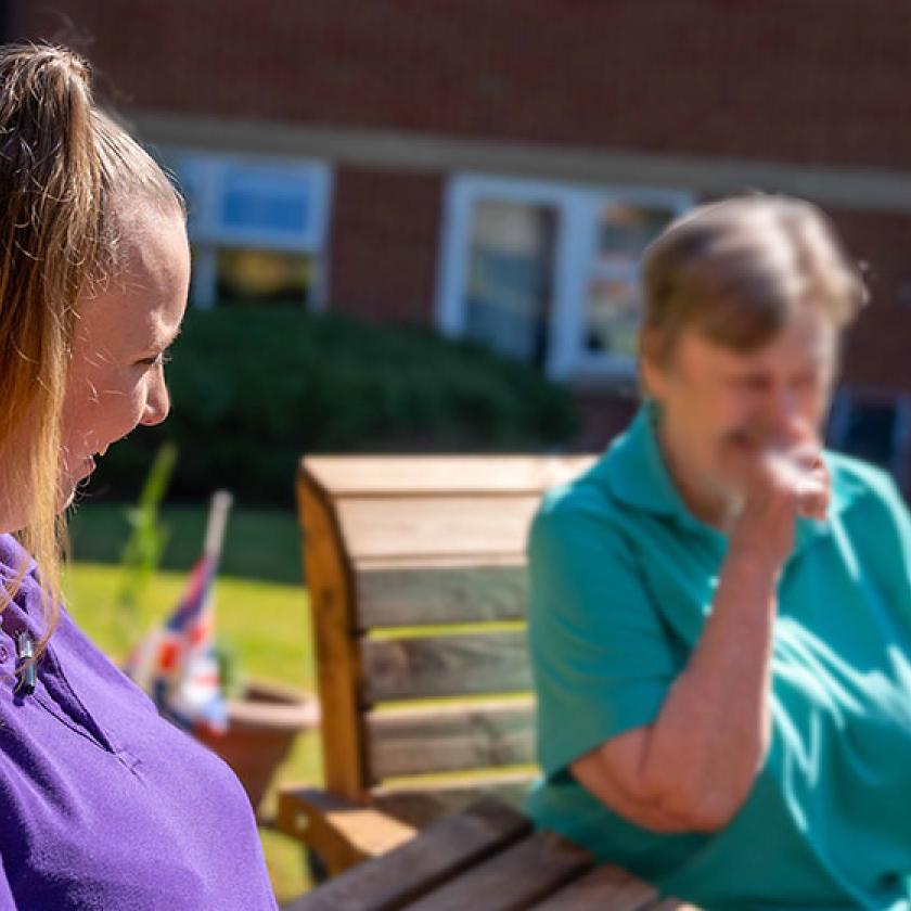 Image of two women sat on benches outdoors