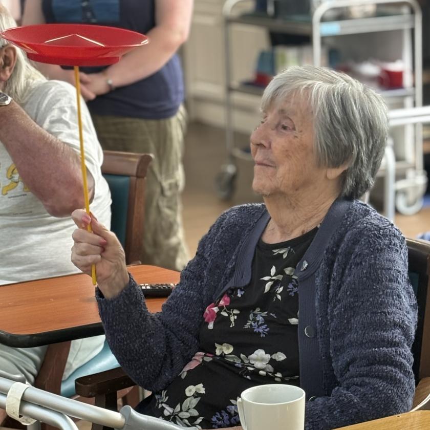 Care home resident Betty tries her hand at plate spinning