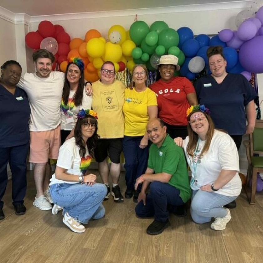 The team at Forefaulds smile wearing their brightest and boldest colours for their Pride celebrations