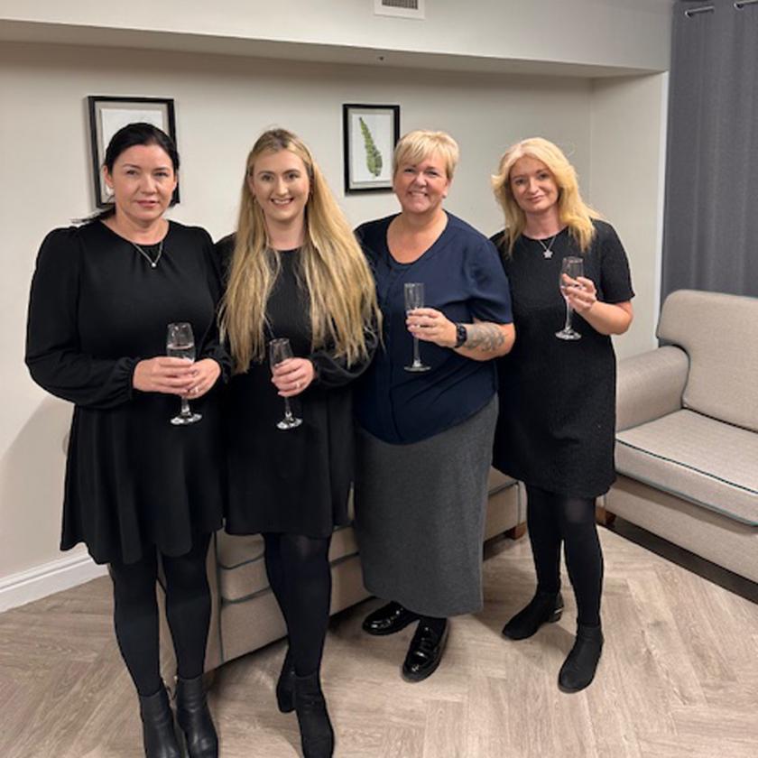 Staff stood together smiling