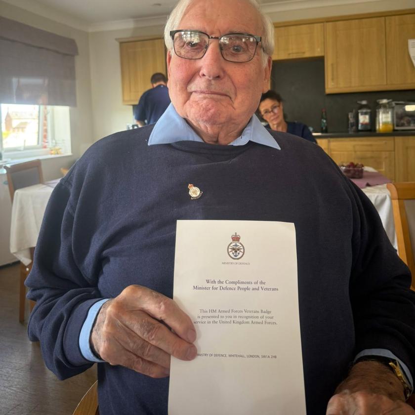 Resident smiling holding badge