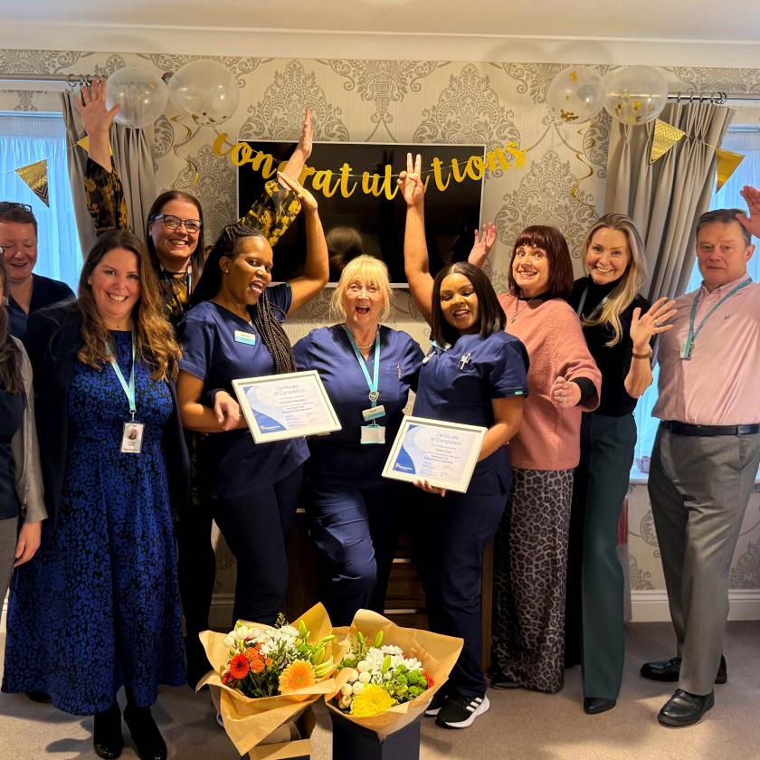 Staff stood together smiling