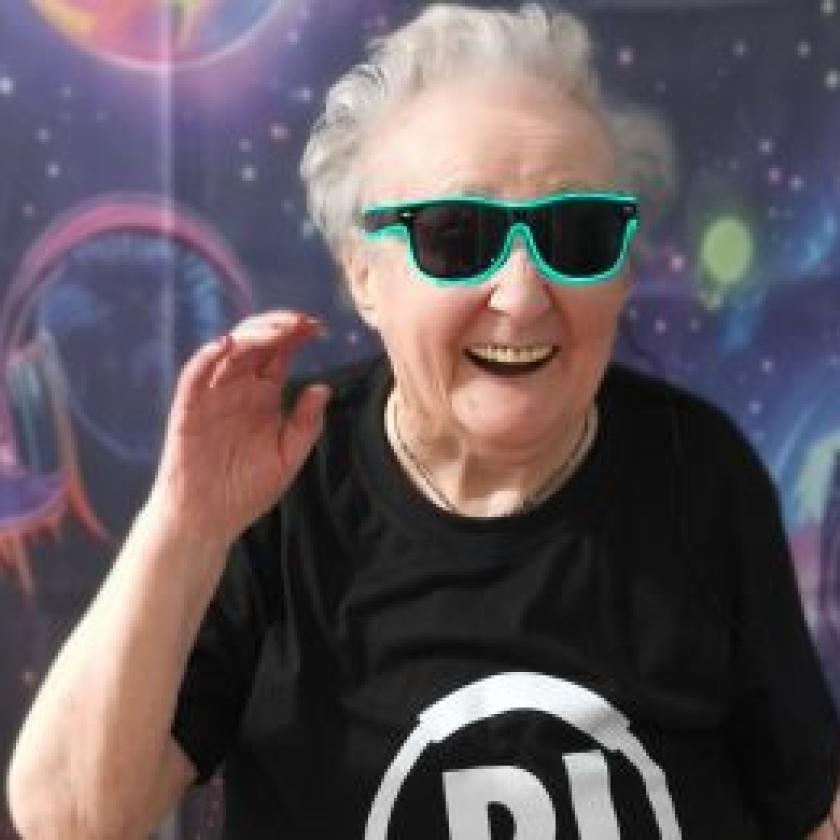 Resident smiling and dancing wearing sunglasses