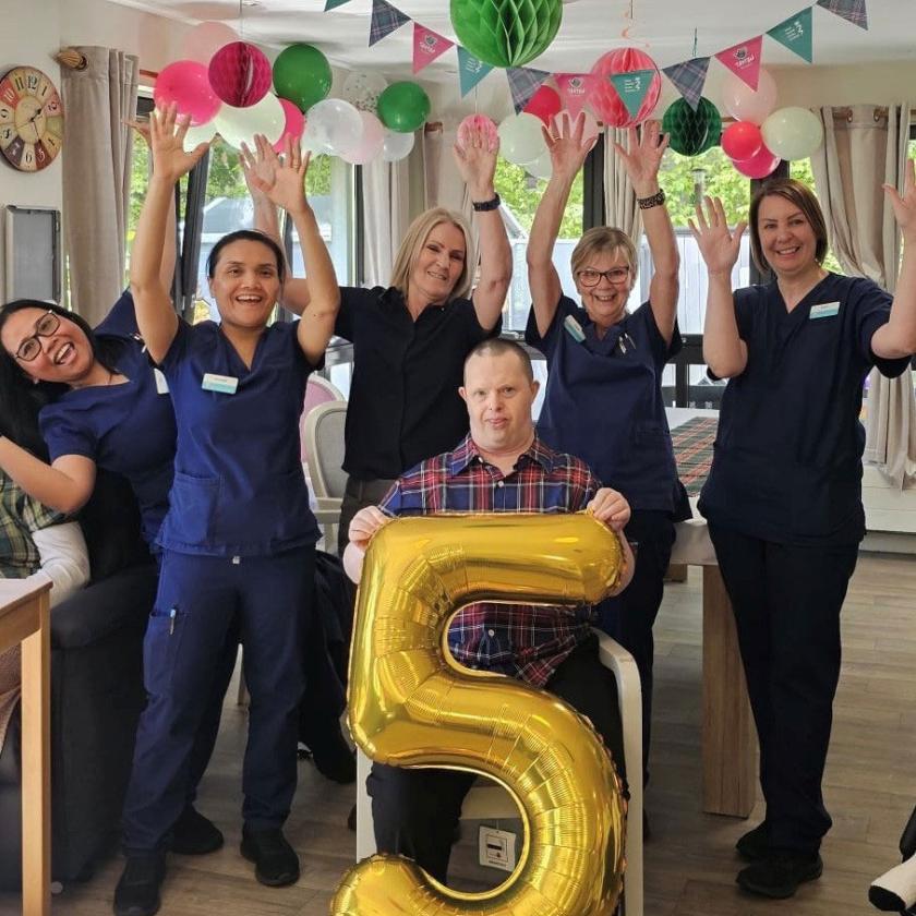 Staff stood together smiling