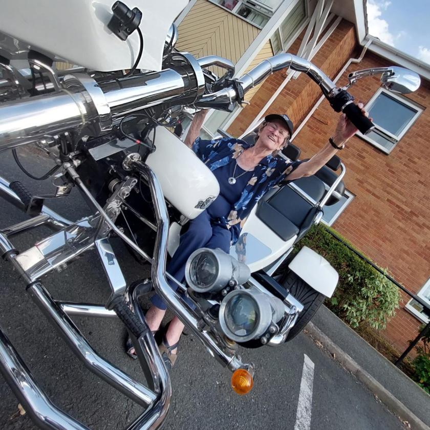 Resident Jane Mackay, sitting on a motorbike