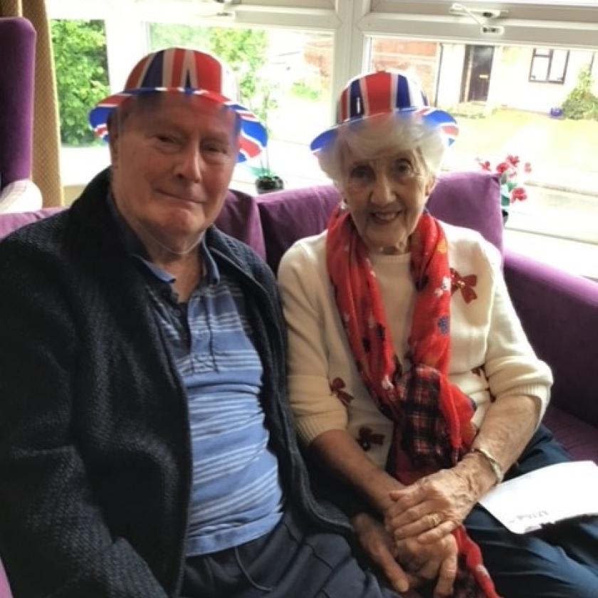 Peter and Carol wearing Union Jack hats to celebrate the King's Coronation