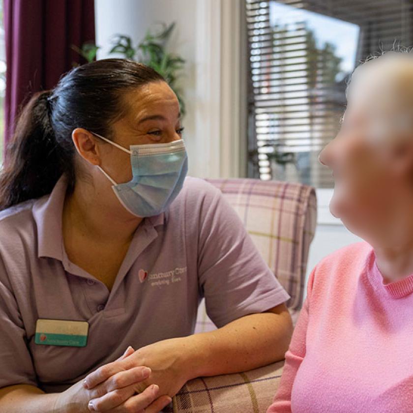 A care assistant chats with a resident
