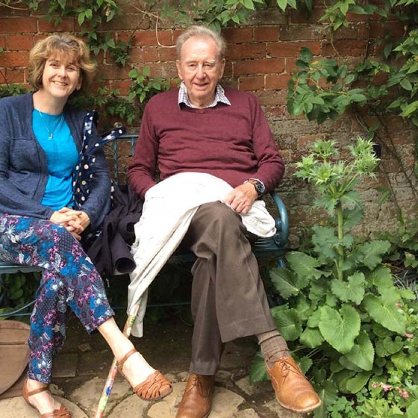 Alison Adcock and her late father Michael Atkinson sitting on a garden bench at Heathlands Residential Care Home
