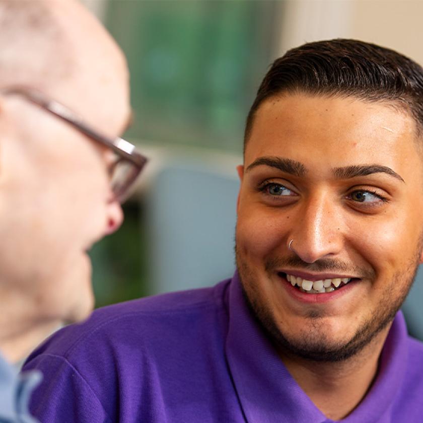 Sanctuary care staff smiling with resident