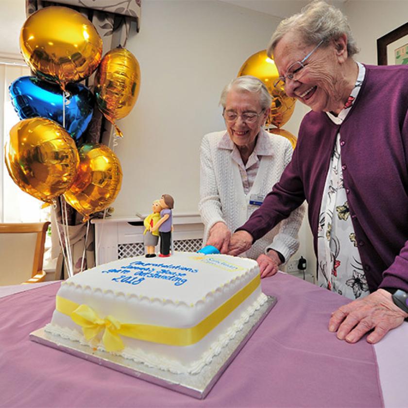 Lammas House residents cutting a cake