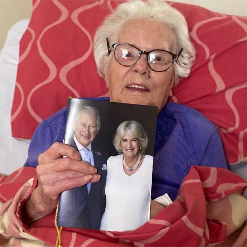 Birchwood resident Emma holding a birthday card from King Charles and Camilla