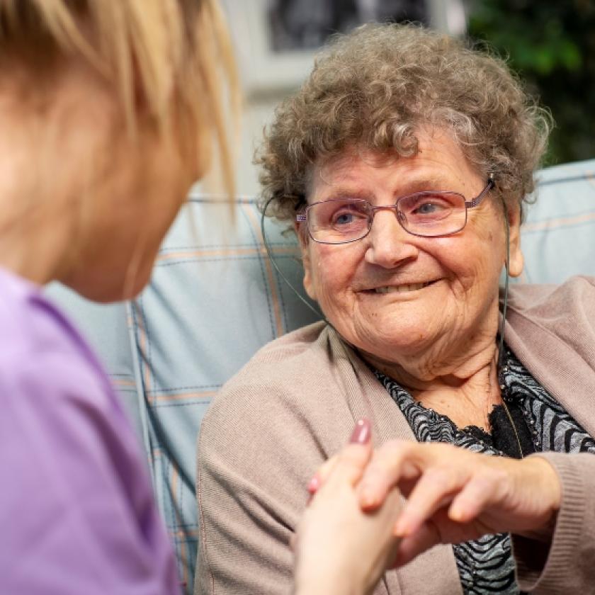 Resident, Kathleen, enjoys a chat with a member of the team