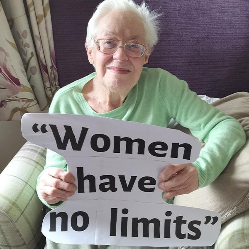 Lime Tree resident Margaret holding a piece of paper stating "Women have no limits"