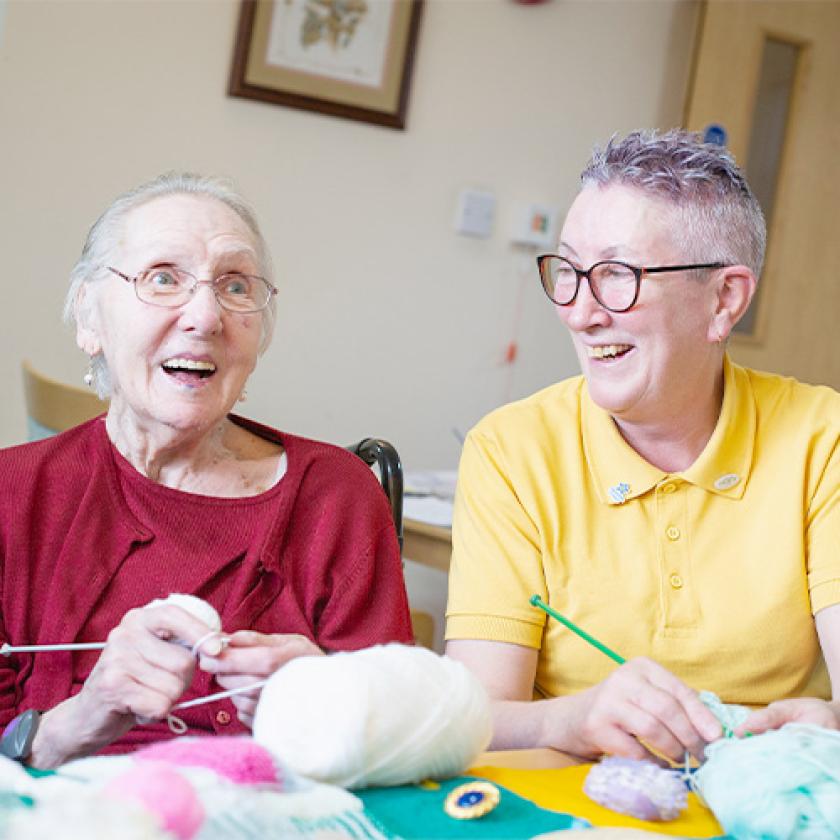 Sanctuary Care resident and staff member knitting